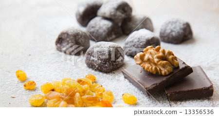 Two pieces of chocolate and a wallnut on it.Small chocolate bisc 13356536