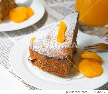 A piece of homemade apricot pie on the white plate 13356537