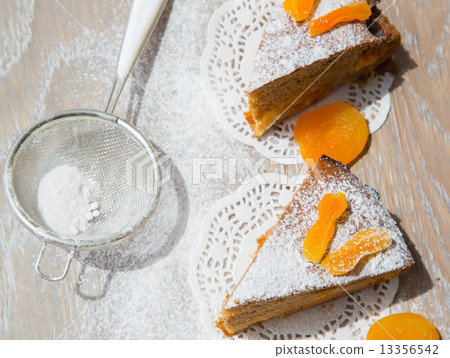 Two pieces of apricot pie on the wooden surface Two pieces of apricot pie on the wooden surface 13356542