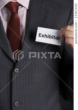 Businessman Attaching Exhibitor Badge To Jacket Businessman Attaching Exhibitor Badge To Jacket 13361430