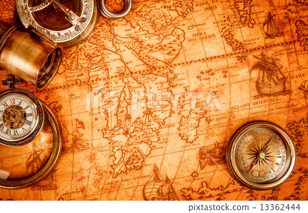 Vintage magnifying glass lies on an ancient world map 13362444