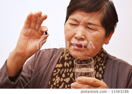 Woman taking medicine 13363286