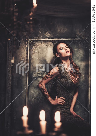 Tattooed beautiful woman in old spooky interior 13363642