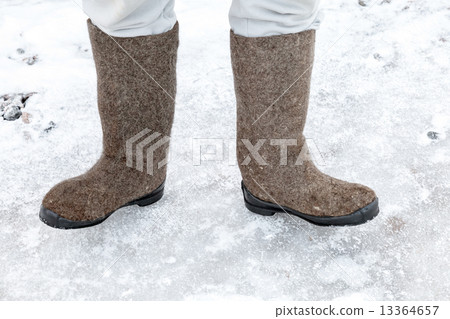 Male feet with traditional Russian felt boots 13364657