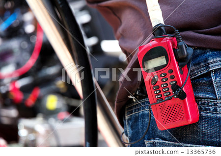 Close-up of male with Walkie talkie  13365736