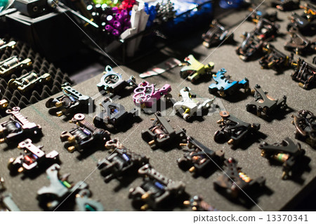 Table with  tattoo machines assortment 13370341