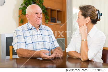 Serious mature couple talking 13370438