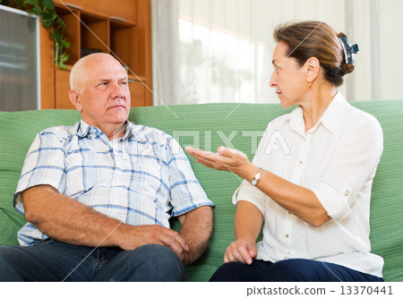 mature couple having serious talking 13370441