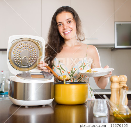 Housewife cooking with multi cooker 13370505