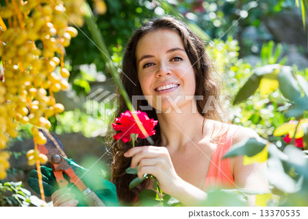Happy woman in gardening 13370535