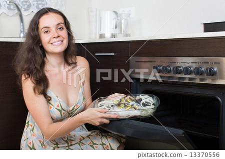 Woman cooking fish at kitchen Woman cooking fish at kitchen 13370556