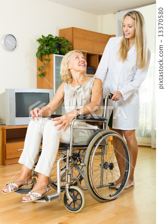 Smiling woman in wheelchair 13370580