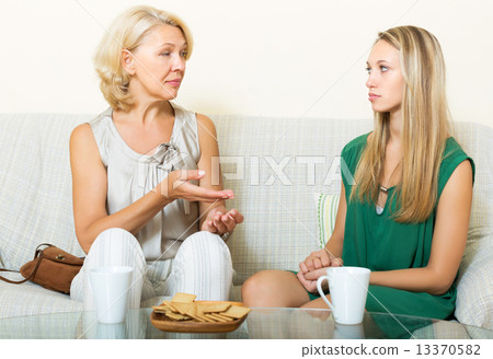 Serious mother and daughter talking 13370582