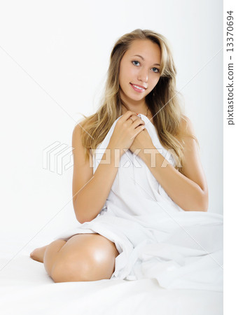 woman sitting with white sheet 13370694