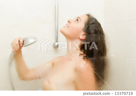 Woman staying in shower cabinet 13370719