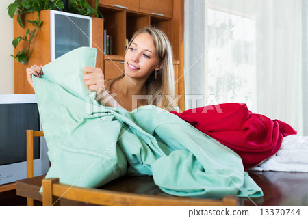 Woman looking at new curtains 13370744