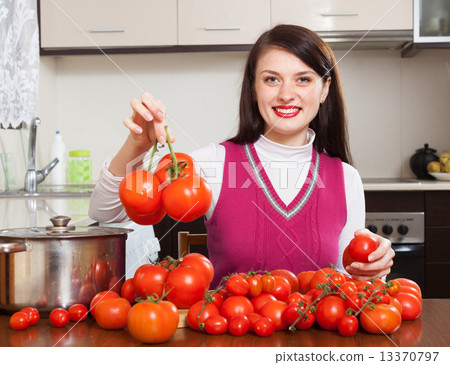 Happy woman with red tomatoes 13370797