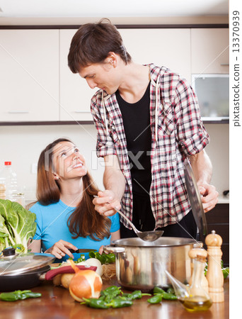 Happy loving couple cooking together Happy loving couple cooking together 13370939