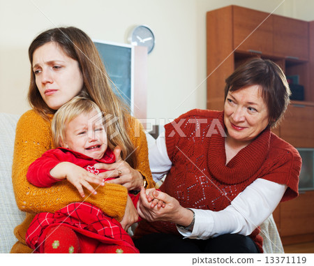 young sadness mother with crying baby and grandmother young sadness mother with crying baby and grandmother 13371119