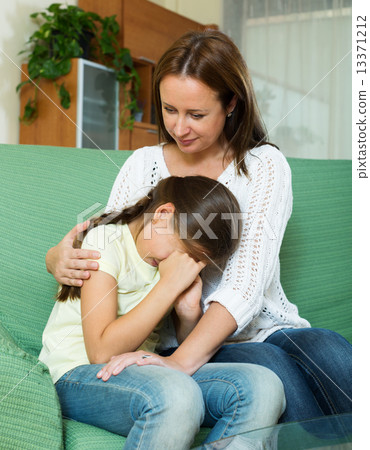 Woman comforting crying daughter Woman comforting crying daughter 13371212