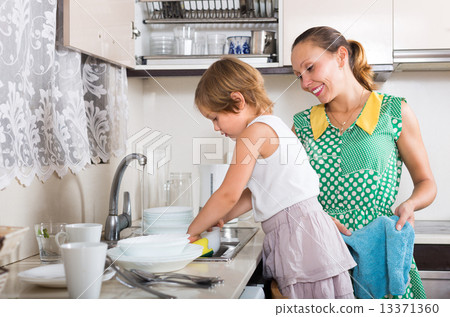 Girl helping mother washing dishes 13371360