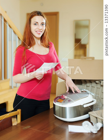 cheerful woman reading guarantee card 13371390