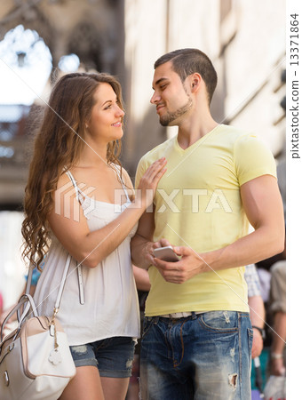 Couple with smartphone at street 13371864