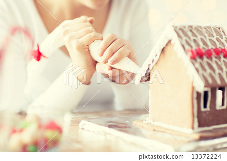 close up of woman making gingerbread house at home close up of woman making gingerbread house at home 13372224