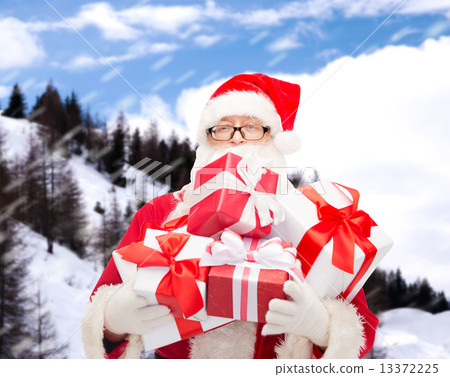 man in costume of santa claus with gift boxes 13372225