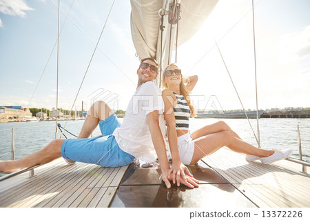smiling couple sitting on yacht deck smiling couple sitting on yacht deck 13372226