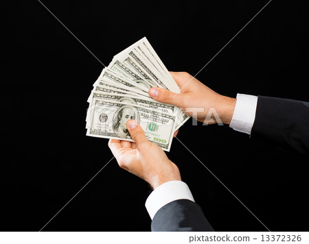 close up of male hands holding dollar cash money close up of male hands holding dollar cash money 13372326