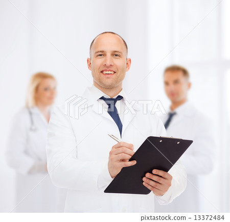 smiling male doctor with clipboard 13372484