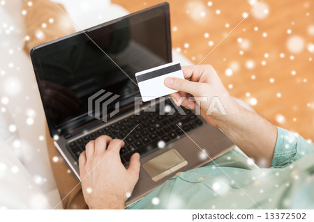 close up of man with laptop and credit card close up of man with laptop and credit card 13372502