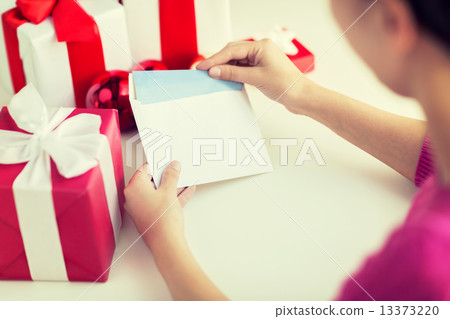 close up of woman with letter and presents 13373220
