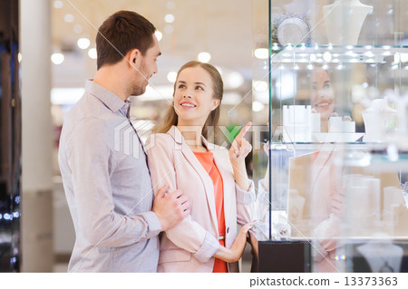 Stock Photo: couple looking to shopping window at jewelry store