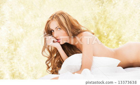 beautiful naked woman lying in bed 13373638