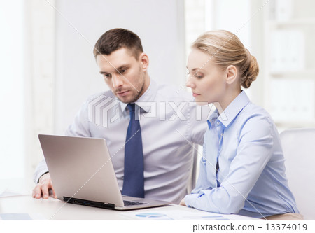 business team working with laptop in office 13374019