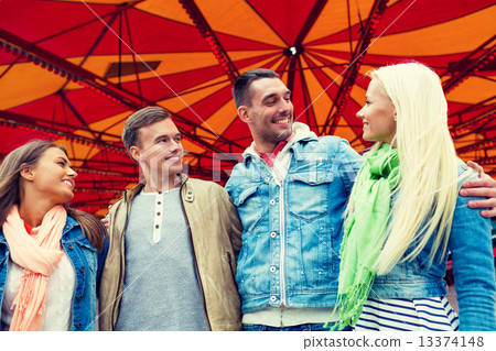 group of smiling friends in amusement park group of smiling friends in amusement park 13374148
