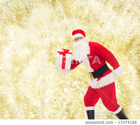 man in costume of santa claus with gift box man in costume of santa claus with gift box 13374188