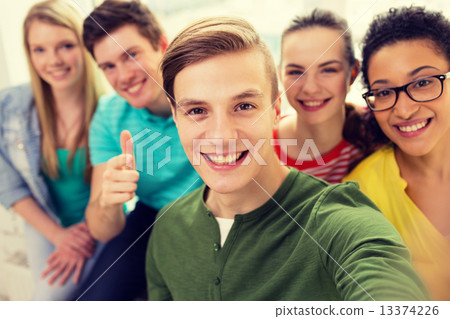 five smiling students taking selfie at school five smiling students taking selfie at school 13374226