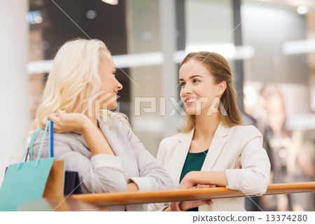 happy young women with shopping bags in mall happy young women with shopping bags in mall 13374280