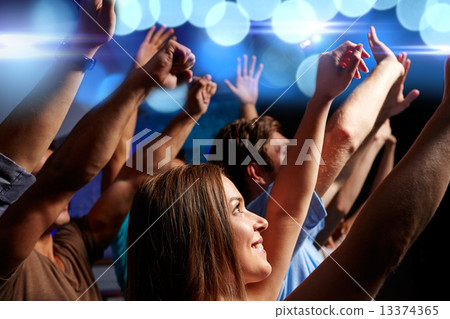 smiling friends at concert in club 13374365