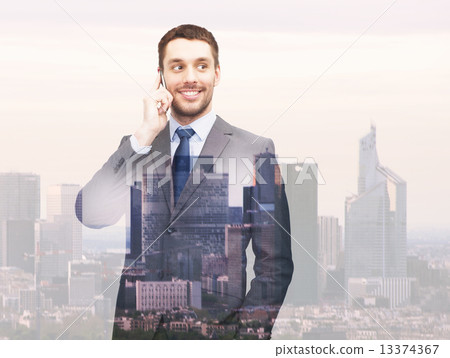 smiling young businessman over city background 13374367
