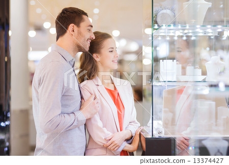 Stock Photo: couple looking to shopping window at jewelry store