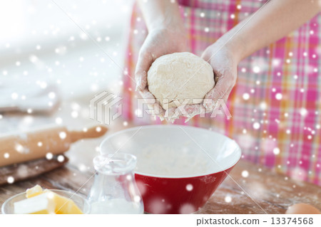 close up of female hands kneading dough at home 13374568