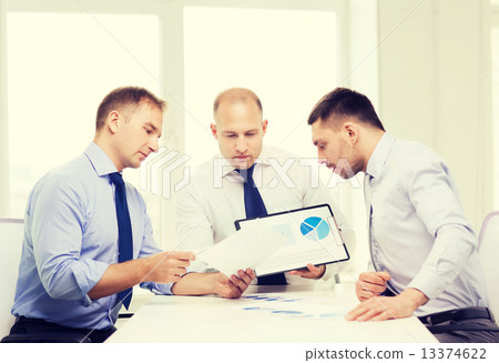 serious businessmen with papers in office 13374622