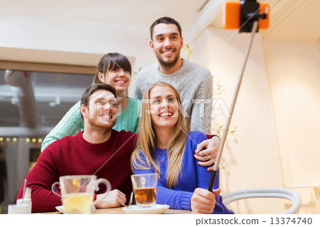 group of friends taking selfie with smartphone group of friends taking selfie with smartphone 13374740