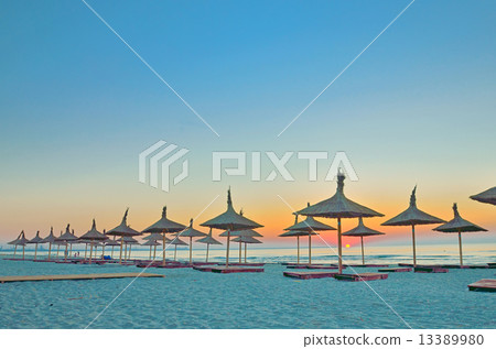 wicker beach umbrellas on the beach 13389980