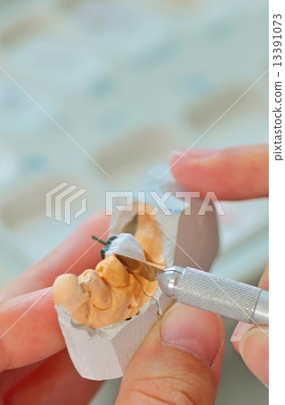 hand of technician in a dental laboratory manufacturing hand of technician in a dental laboratory manufacturing 13391073