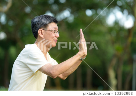 One male chinese elderly doing morning exercise in a park One male chinese elderly doing morning exercise in a park 13392998